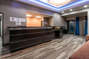 a lobby with a reception desk in a building at Super 8 by Wyndham San Antonio Near Fort Sam Houston in San Antonio