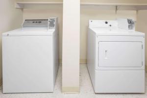 a white washer and dryer in a room at Super 8 by Wyndham Davenport in Davenport