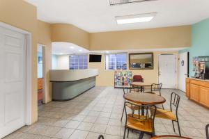 a room with tables and chairs and a kitchen at Travelodge by Wyndham San Diego SeaWorld in San Diego