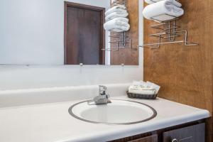 a bathroom with a sink and a mirror at Knights Inn Boardman in Boardman +11 photos