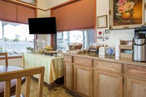a kitchen with a counter with a table and a window at Knights Inn Boardman in Boardman