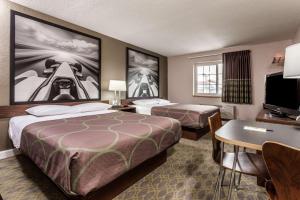 a hotel room with two beds and a desk at Super 8 by Wyndham Willows in Willows