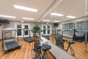 a gym with several treadmills and exercise bikes at Super 8 by Wyndham Alexander City in Alexander City