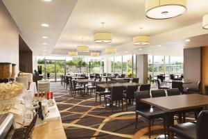 un ristorante con tavoli, sedie e finestre di Travelodge by Wyndham Niagara Falls Fallsview a Niagara Falls