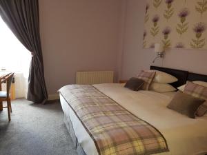 a hotel room with a bed and a window at Ardshiel Hotel in Campbeltown