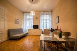 a living room with a couch and a table at Jewish Synagogue Ruterra Suite in Prague