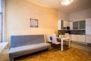 a living room with a couch and a table at Jewish Synagogue Ruterra Suite in Prague