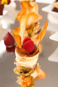 a stack of food with fruit on top of it at Arcadia Boutique Hotel in Bratislava