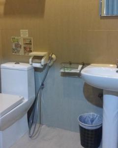 a bathroom with a toilet and a sink at Hotel 01 Batam in Batam Center