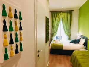 a bedroom with green walls and a bed and a window at Grande Archivio Napoli 22 in Naples