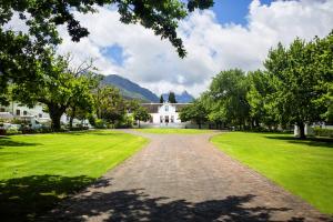 a large white house with a tree in front of it at Lanzerac Hotel & Spa in Stellenbosch