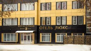 a yellow and black building with a sign on it at Hotel Royal Poltava in Poltava