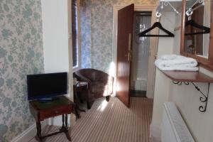 A television and/or entertainment center at The West Bank Guest House 