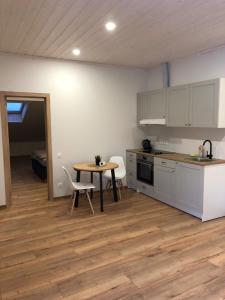 a kitchen and dining room with a table and chairs at Villa Midesta in Šiauliai