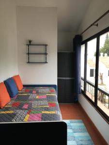 a bedroom with a bed and a large window at T0 Pedras D'el Rei in Tavira