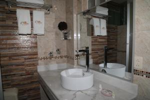 a bathroom with a sink and a mirror at Sol Plaza Hotel in Puno