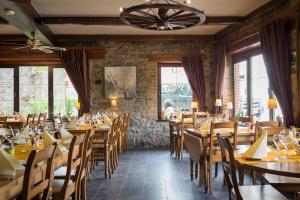 a dining room with wooden tables and chairs at Auberge de la Lesse in Celles