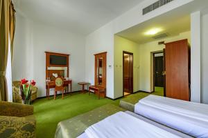 Postel nebo postele na pokoji v ubytování Hotel Palace
