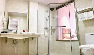 a bathroom with a shower and a sink at Ocean Star Hotel in Koror