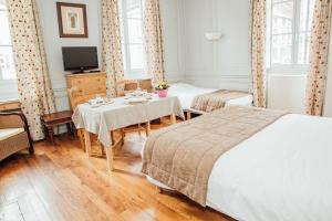 Postel nebo postele na pokoji v ubytování Appart Hotel Charles Sander