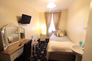 A bed or beds in a room at The West Bank Guest House 