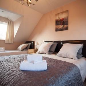 a hotel room with a bed and a desk at Ballas Farm Country Guest House in Bridgend