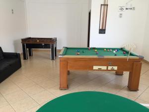 a living room with a pool table and a couch at Hotel Nossa Senhora do Carmo in Ilha Comprida