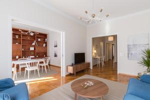 a living room with a table and a dining room at Chic Flat in the Heart of Athens by UPSTREET in Athens