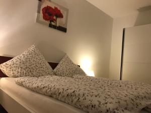 a bedroom with a bed with red flowers on it at Haus Sonnentag in Bad Bertrich