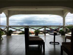 a balcony with a chair and a table and a view at Annexe de l'Hotel de la Poste in Diego Suarez