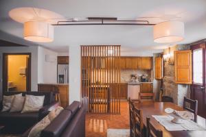 a living room and kitchen with a table and a couch at Casa da Obrinha in Bouro
