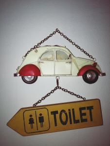 ein Schild mit einem Auto, das an einer Kette hängt. in der Unterkunft Nashira Rooms in Florenz