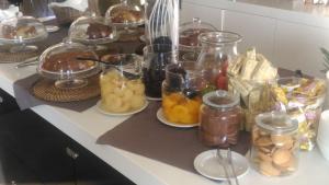 a counter with many jars of food on it at Idea Hotel Plus Savona in Savona