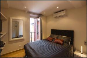 a bedroom with a bed with a mirror and a window at Nice Renting - COLONNA - Best place in Nice Old Town in Nice