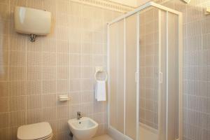 a bathroom with a shower and a toilet and a sink at Albergo La Bussola in Abbadia San Salvatore