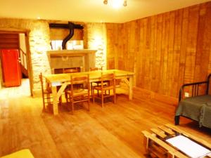 a dining room with a table and chairs and a fireplace at Chez Henriette in Voiteur
