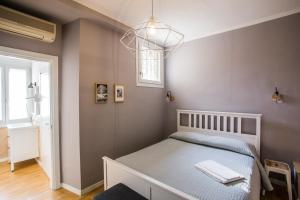 a bedroom with a bed with a gray wall at Ciccio Bed & Breakfast in Bergamo