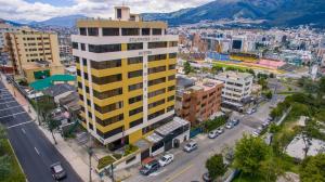 an overhead view of a city with a yellow building at Stanford Suites Hotel in Quito