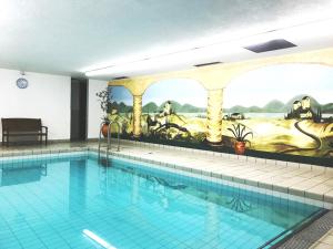 a large swimming pool with a painting on the wall at Ferienwohnung am Walchensee in Walchensee
