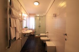 a bathroom with two toilets and a sink and a mirror at B&B Al Picchio in Monopoli +23 photos