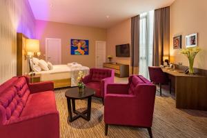 a hotel room with red furniture and a bed at Admiral Hotel in Zagreb