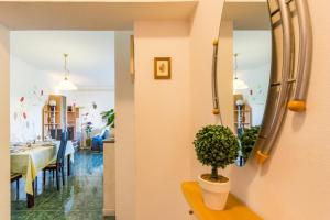 a dining room with a table and a mirror at Apartment Lori in Fažana