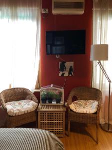 a living room with two chairs and a fish tank on a table at NIDO D'AMORE in Verona