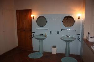 a bathroom with two sinks and two mirrors at Presbytère de jonquiere in Lavaur +36 photos