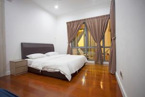 a bedroom with a bed and a large window at Kota Kinabalu Times Square Imago in Kota Kinabalu