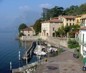 a group of boats docked at a marina on a lake at Appartamento monteisola mara in Monte Isola