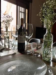 a bottle of wine sitting on a table with glasses at Apartamento Con Encanto San Basilio in Córdoba