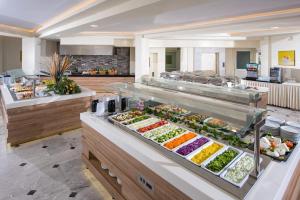 a buffet line with many different types of food at Alexander House Hotel in Agia Pelagia