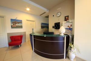 a office with a desk and a red chair at B&B Al Picchio in Monopoli