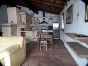 a kitchen with a table and a kitchen with a dining room at Appartamento monteisola mara in Monte Isola